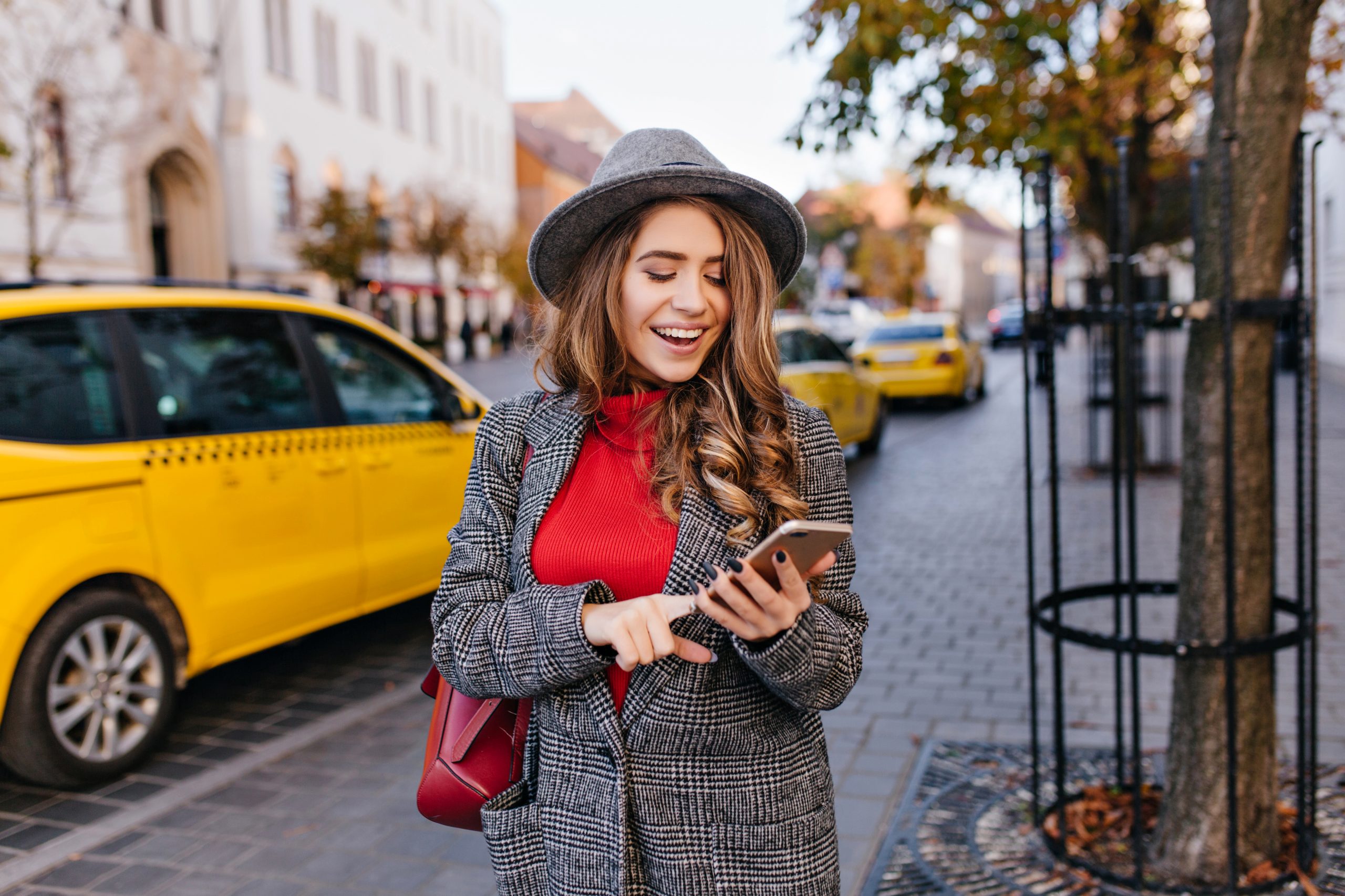 good looking business woman texting message while walking street scaled 1 2